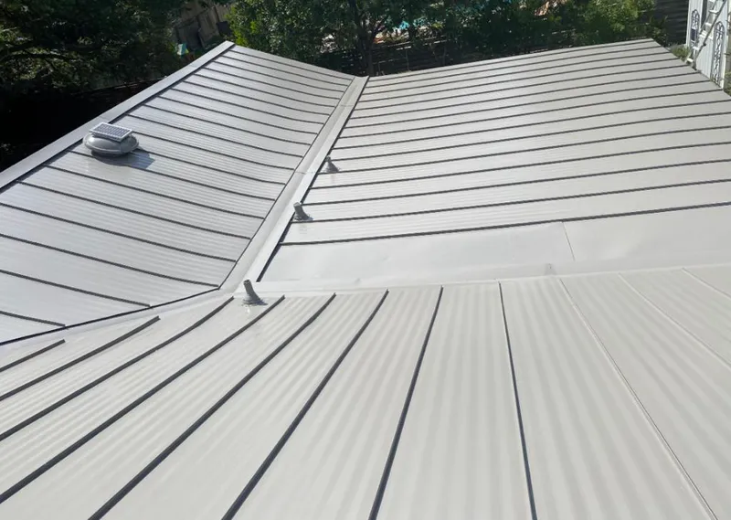 Solar attic fan installed on a metal roof for Roof Ventilation in Vienna